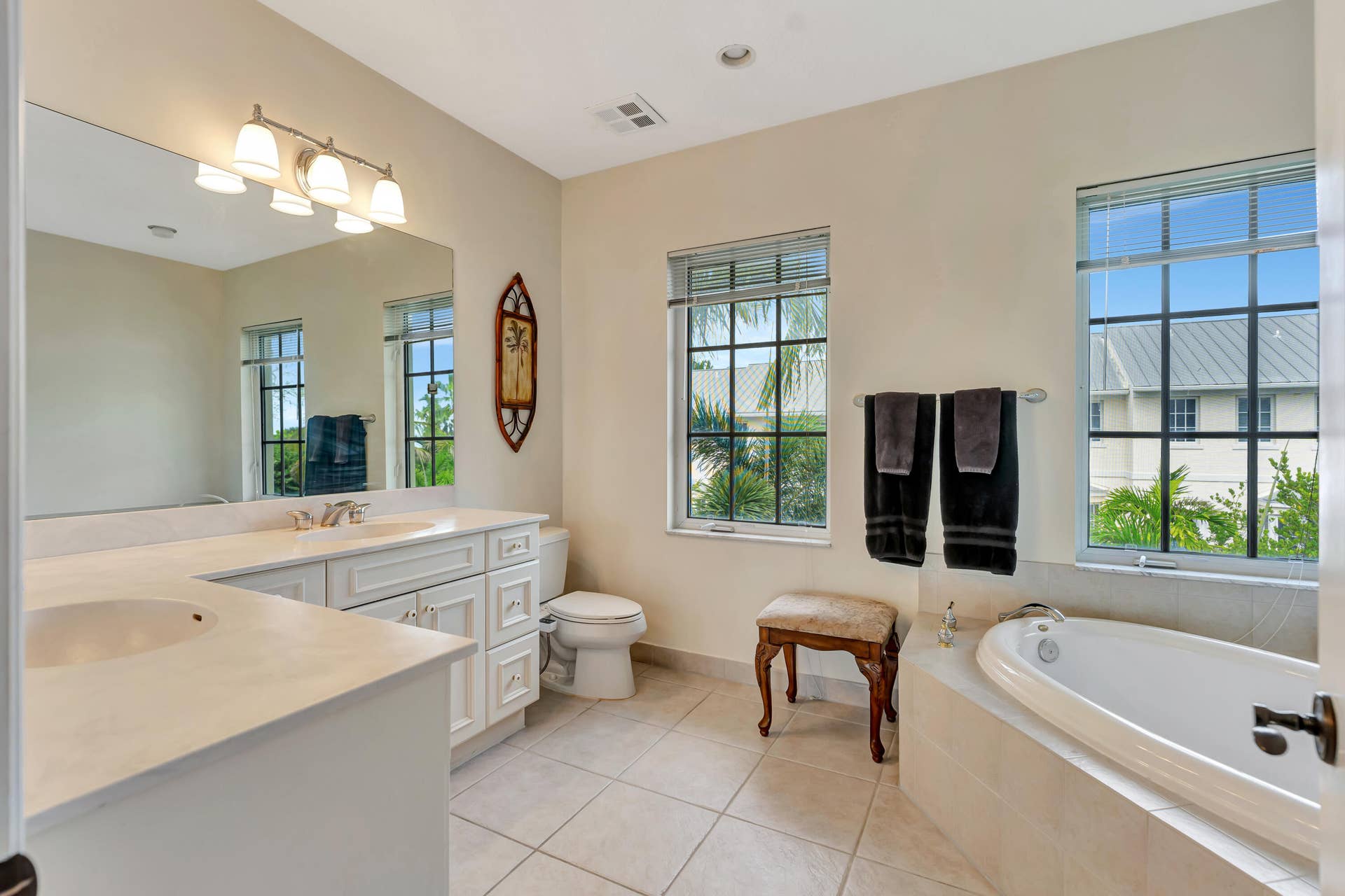 471 JUNO DUNES Way, Juno Beach, FL 33408 Dual vanity with white cabinetry and light-toned countertops
