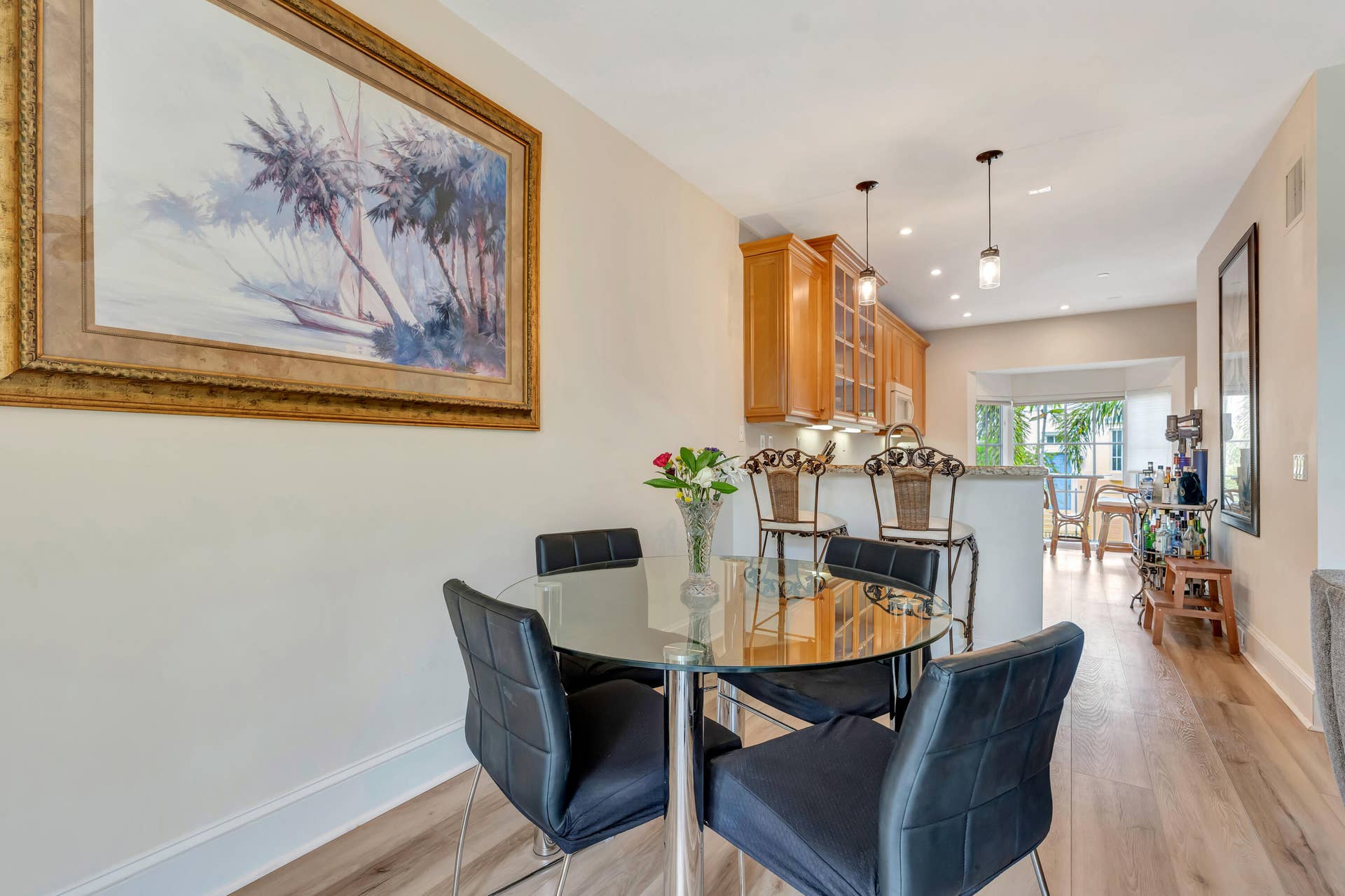471 JUNO DUNES Way, Juno Beach, FL 33408 Wood-finish flooring throughout, with a dining area featuring a built-in kitchen pass-through