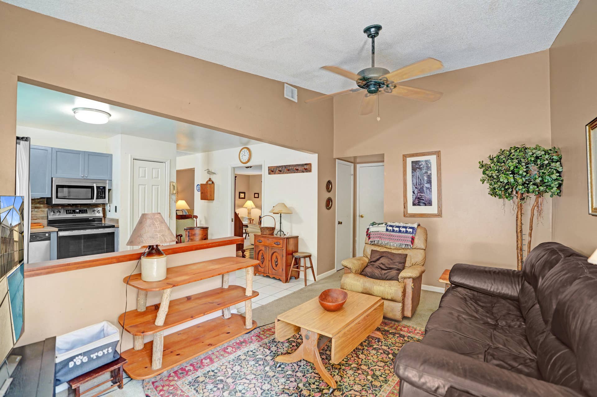 View of family room open to kitchen leads to half bath and attached garage entry.