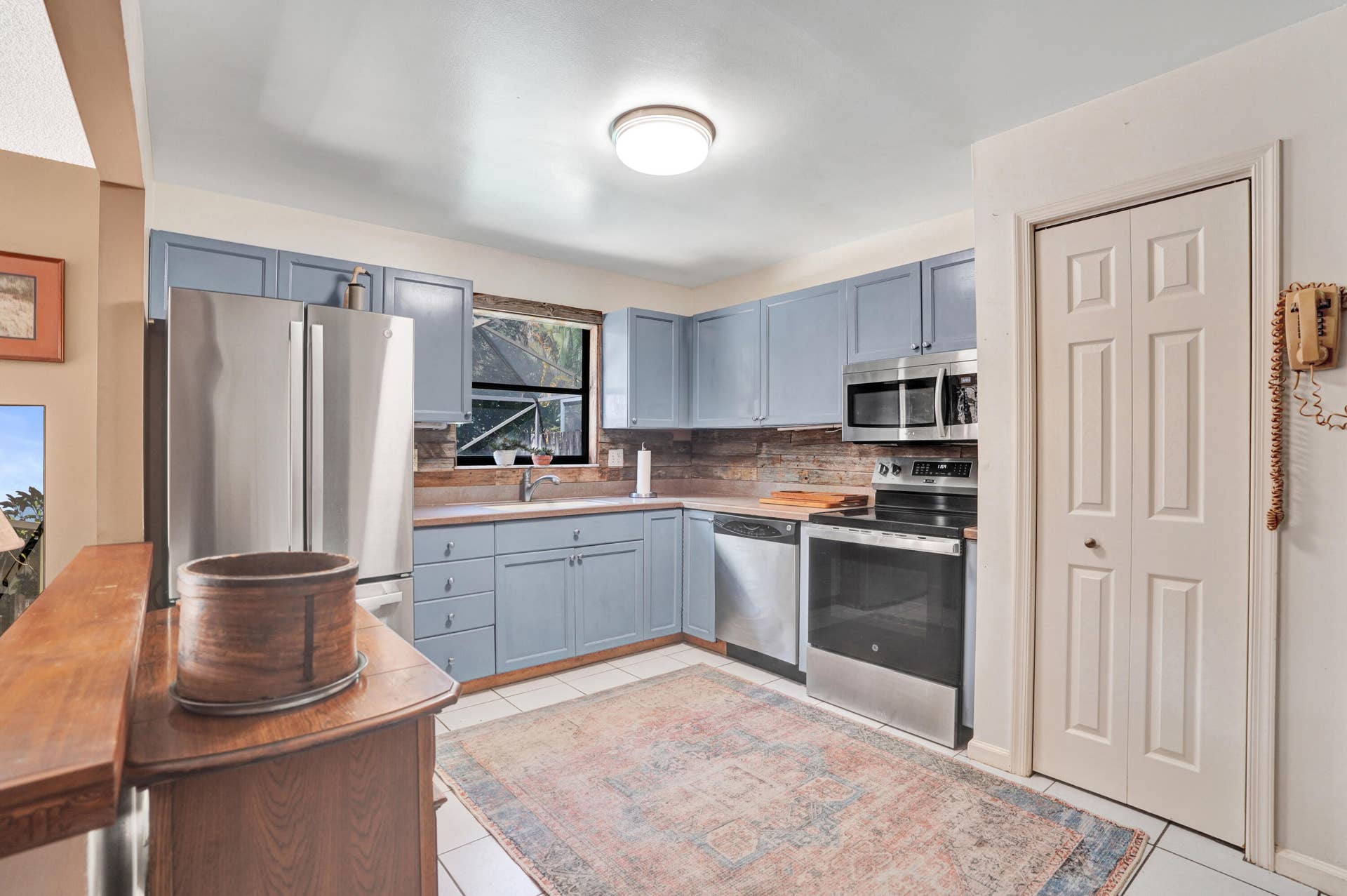 Another view of kitchen with newer appliances and pantry.