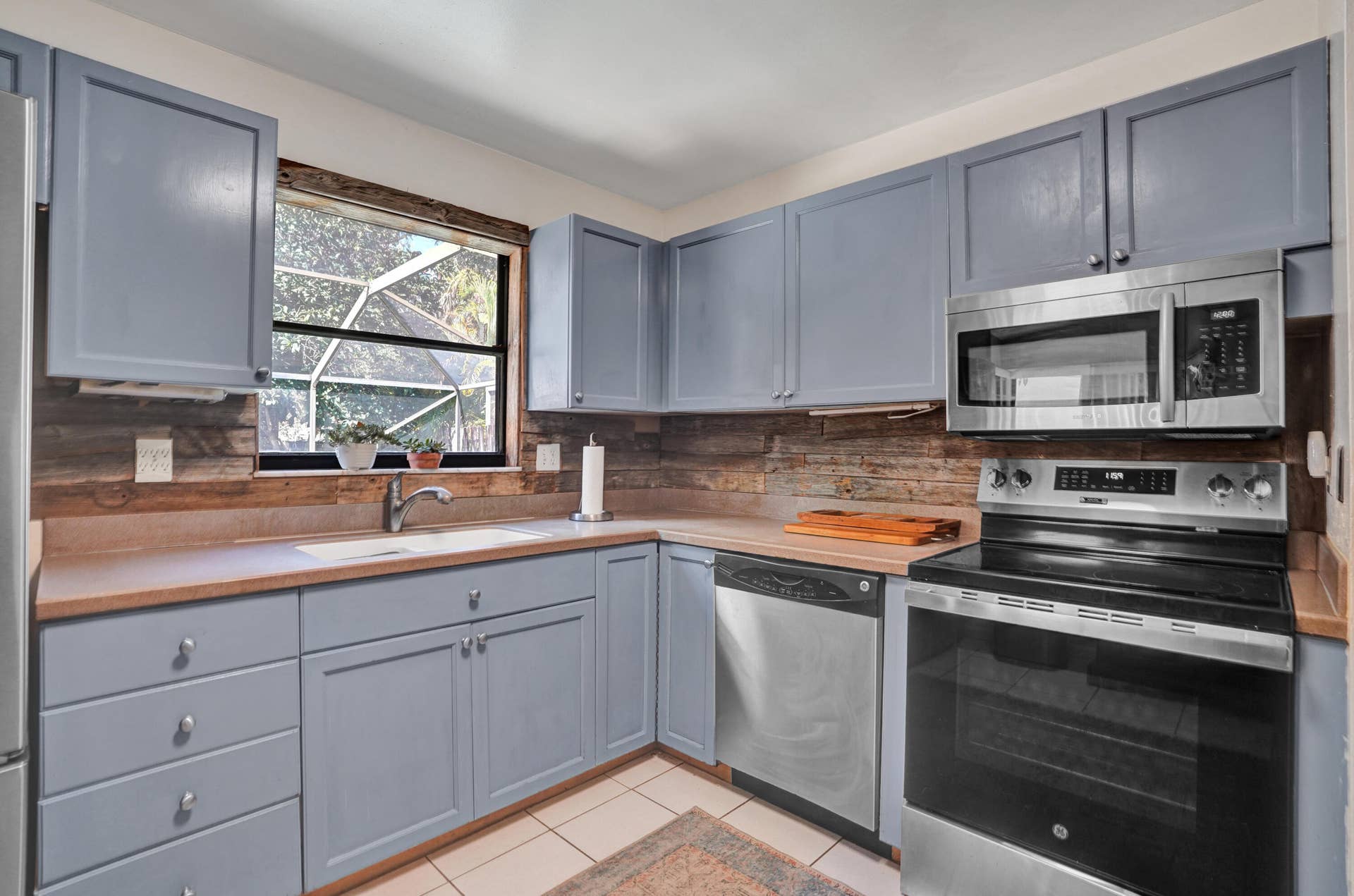 Close up view of kitchen overlooking private back pool area.