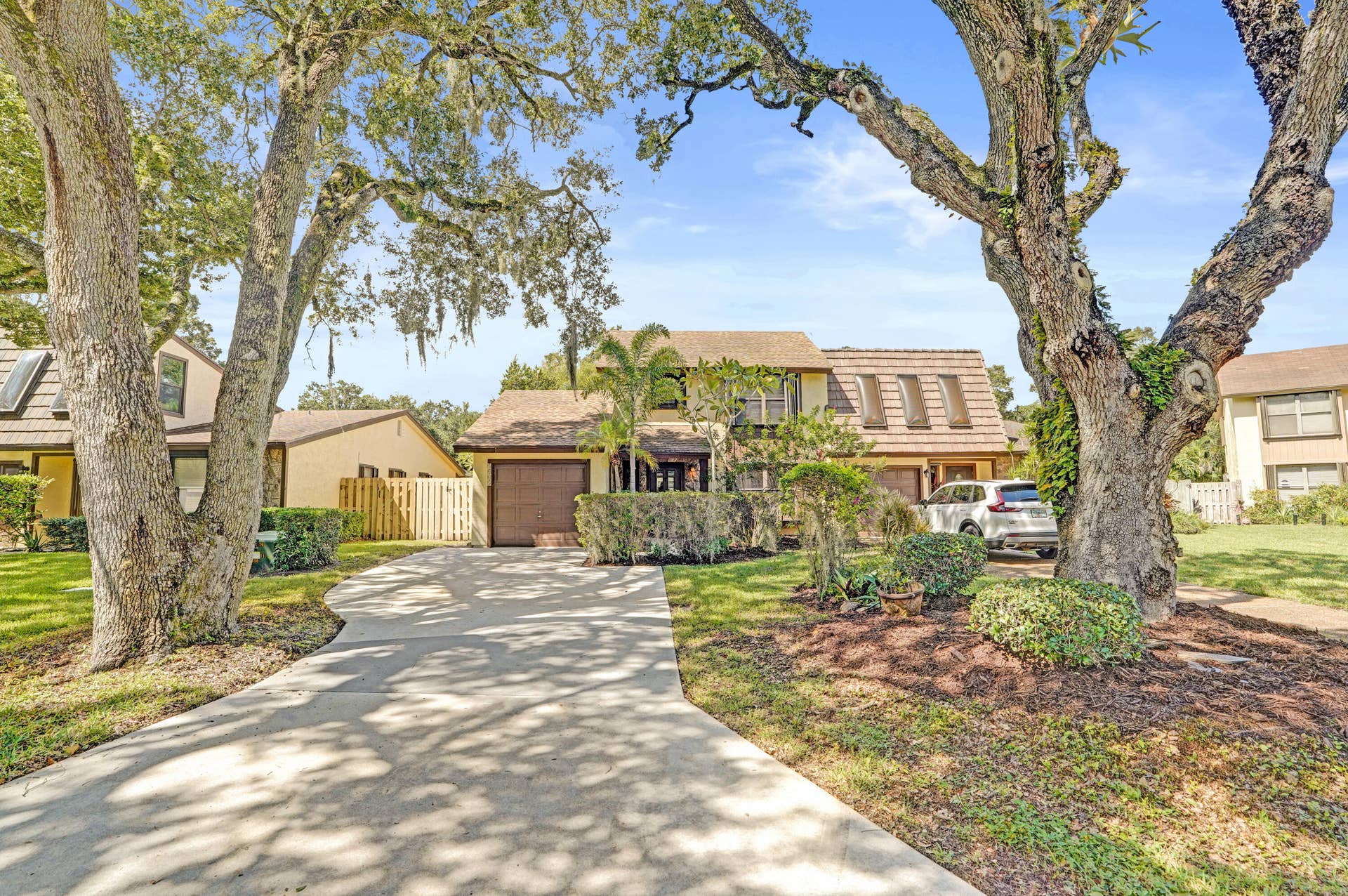 View of extra large drive and 1 car garage