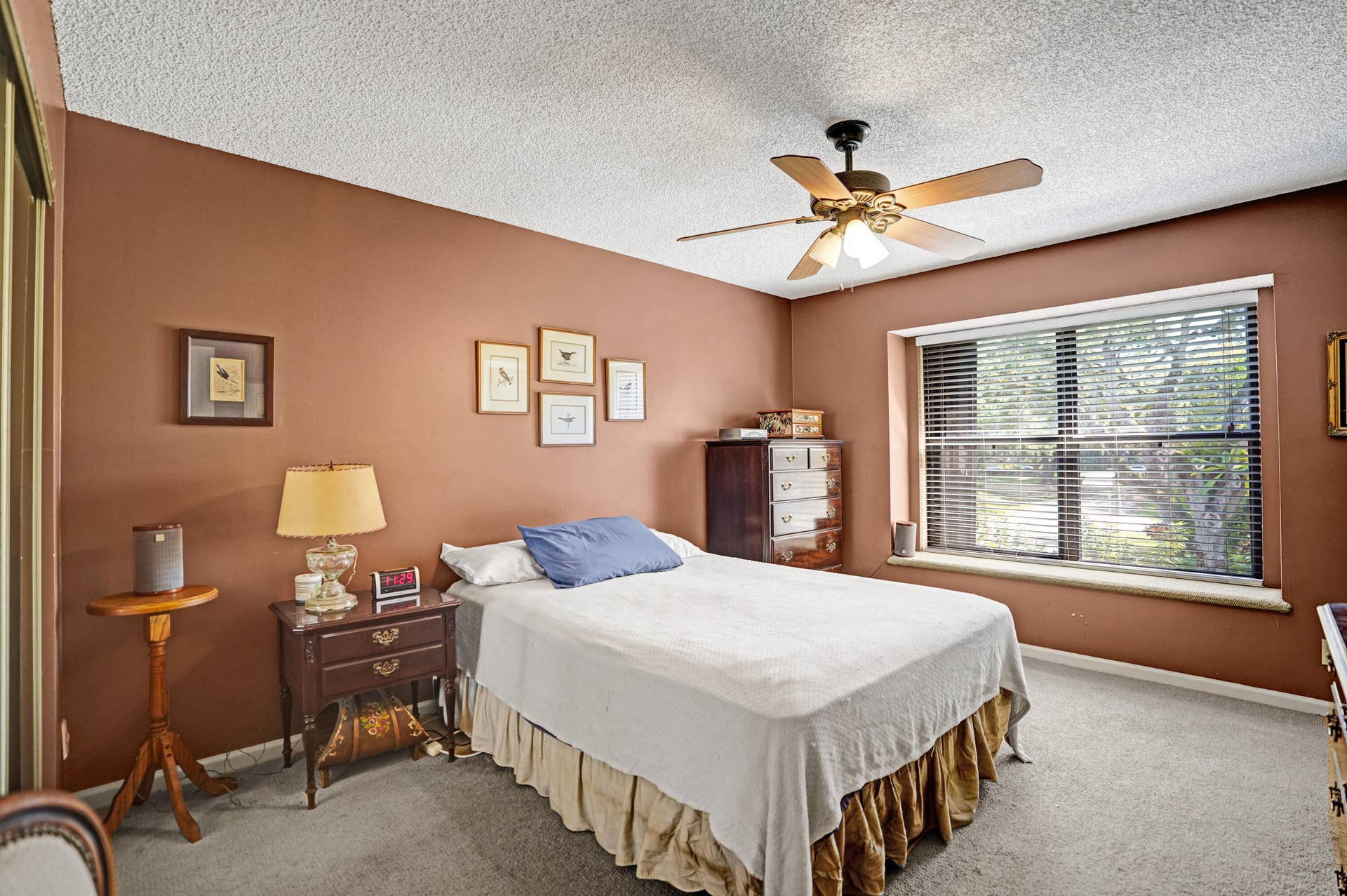View of Primary Bedroom with large window and ceiling fan.