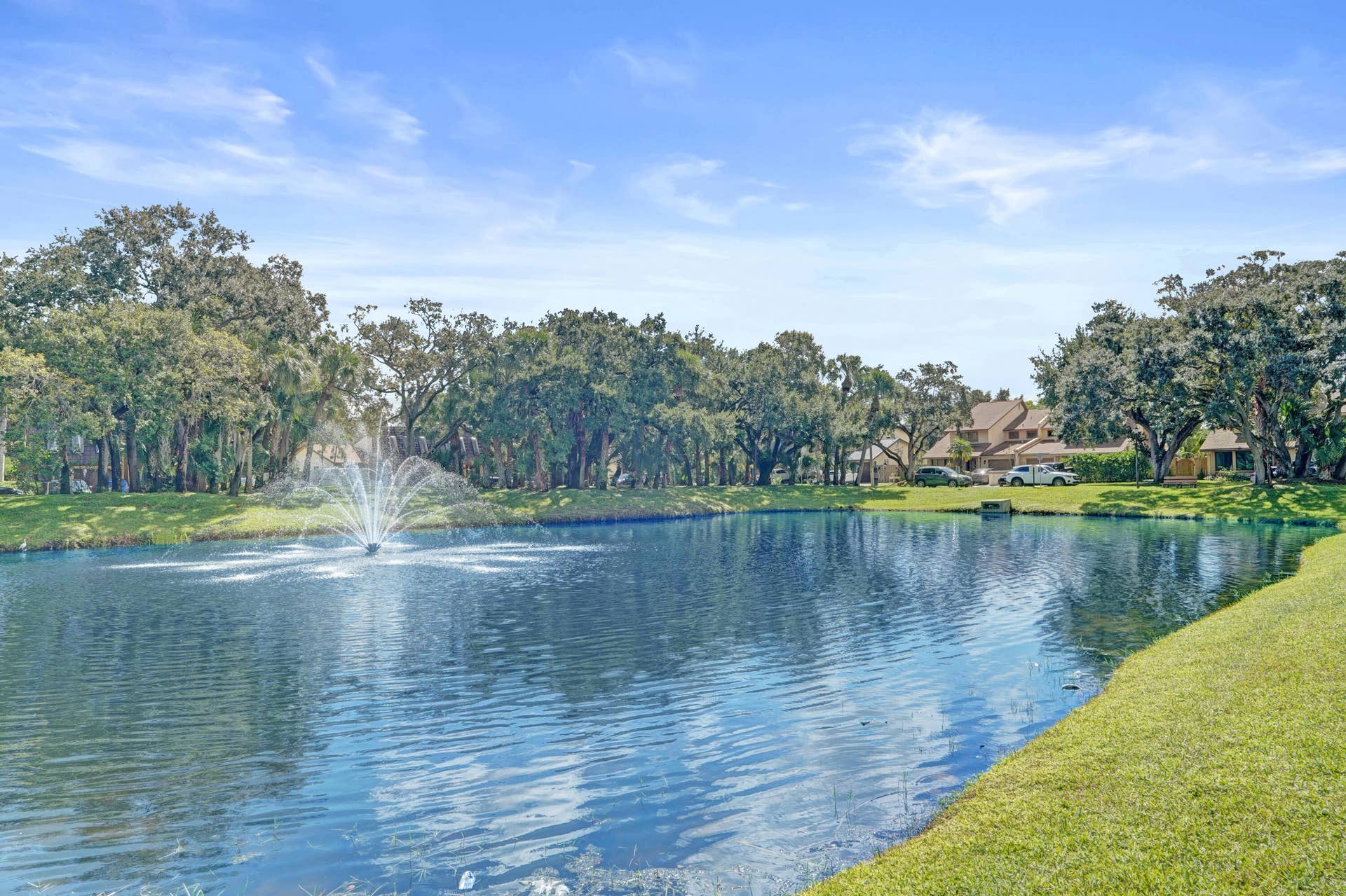 Another view of pond area with fountain and seating benches.