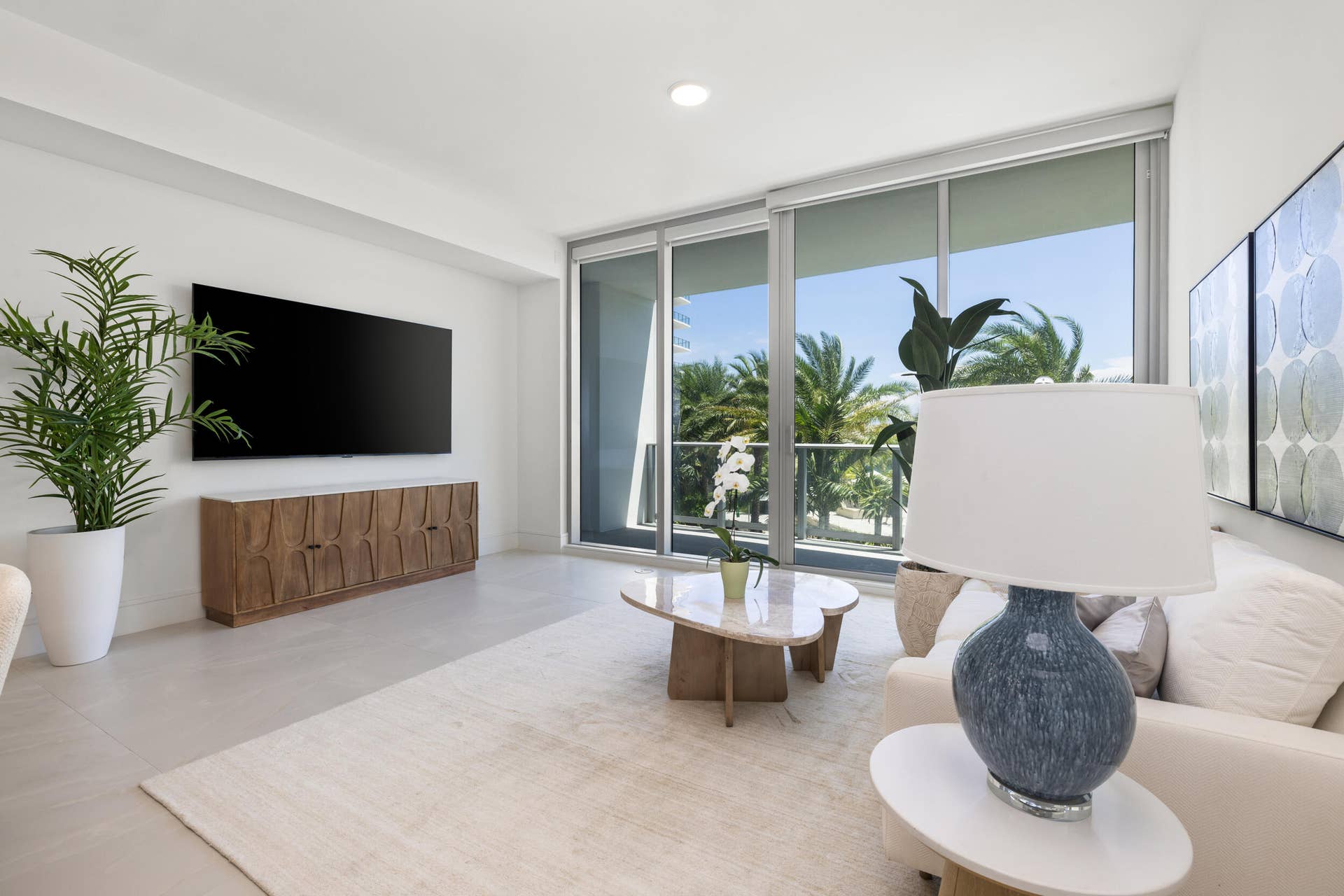 220 Lake Shore Drive, #704, Lake Park, FL 33403 Recessed lighting, large format tile flooring, and floor-to-ceiling sliding glass doors leading to a balcony