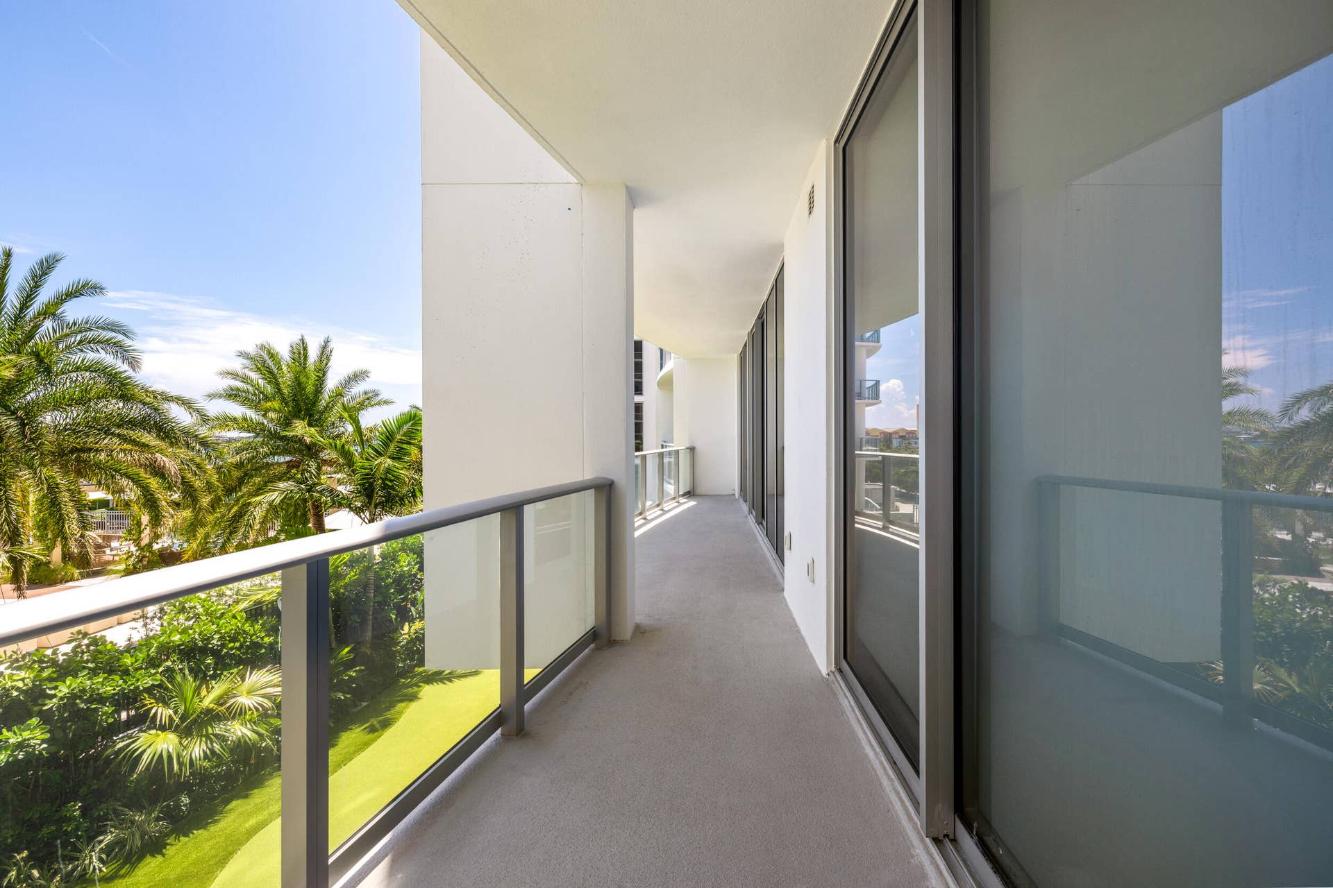 220 Lake Shore Drive, #704, Lake Park, FL 33403 Expansive private balcony with glass panel railing and sliding glass doors