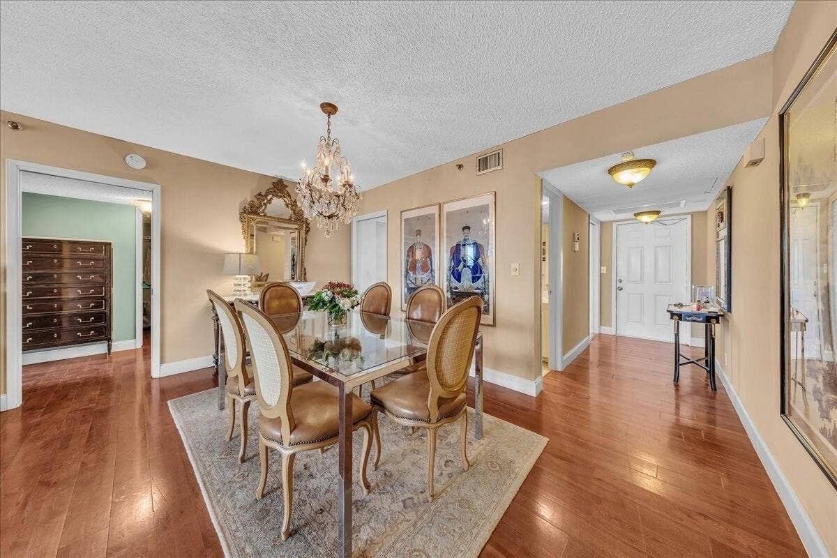 3520 Oaks Way, #904, Pompano Beach, FL 33069 Foyer view and dining area and half bath