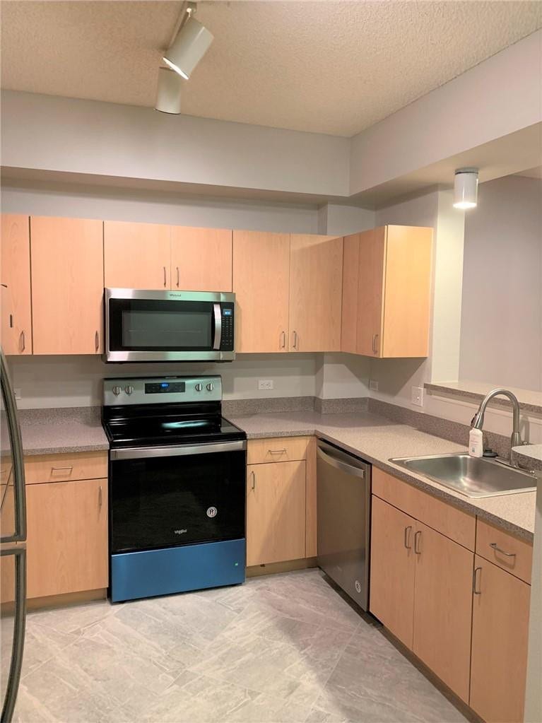 533 NE 3RD Avenue, #115, Fort Lauderdale, Fort Lauderdale, FL 33301 Light wood-finish cabinetry, stainless steel appliances, stainless steel sink with pull-down faucet, composite countertops, and tile flooring