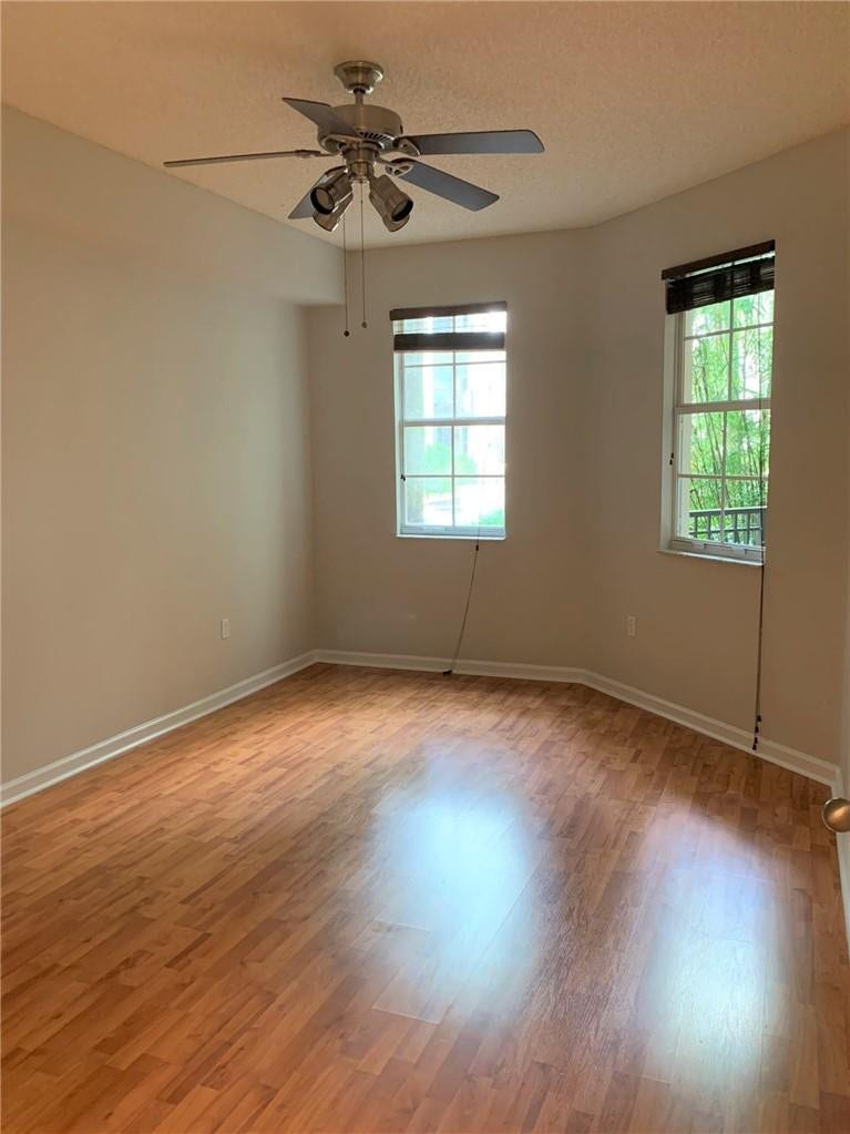 533 NE 3RD Avenue, #115, Fort Lauderdale, Fort Lauderdale, FL 33301 Wood-finish flooring, ceiling fan with integrated lighting, multiple windows with blinds, and neutral wall tones