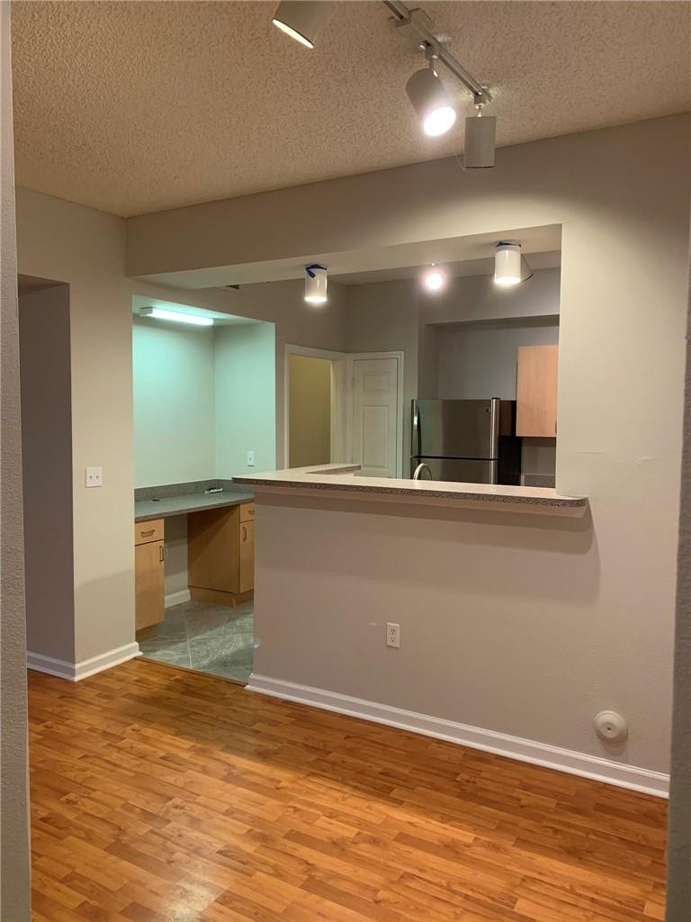 533 NE 3RD Avenue, #115, Fort Lauderdale, Fort Lauderdale, FL 33301 Wood-finish flooring, track lighting, built-in cabinetry, and a pass-through bar counter