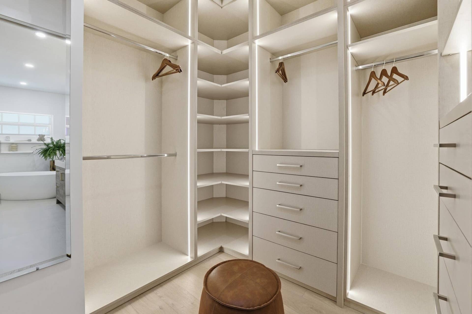 Custom built primary closet with lighting