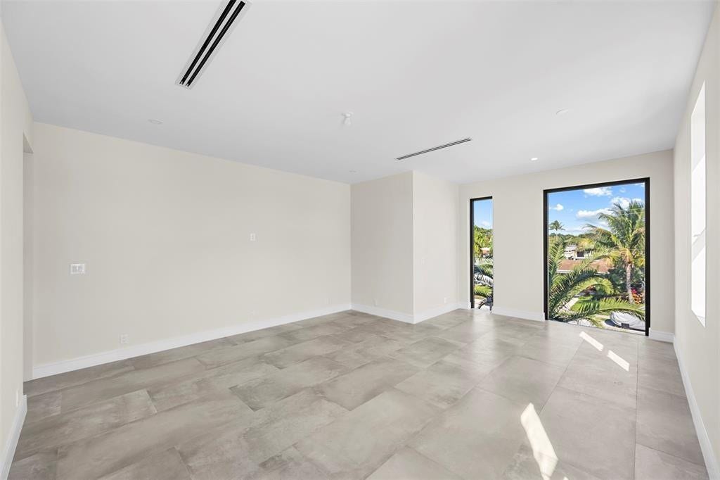 1212 AVOCADO Isle, Fort Lauderdale, Fort Lauderdale, FL 33315 Expansive room featuring large format tile flooring, recessed lighting, and wall-mounted air vents