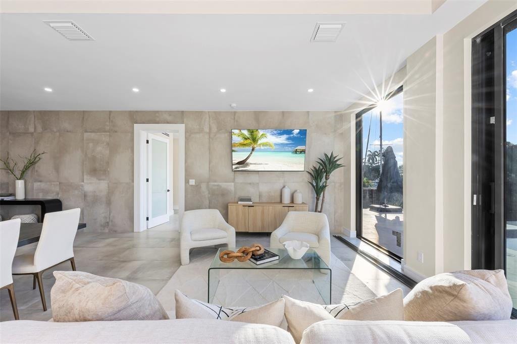 1212 AVOCADO Isle, Fort Lauderdale, Fort Lauderdale, FL 33315 Expansive living space featuring floor-to-ceiling windows, recessed lighting, and large format wall panels