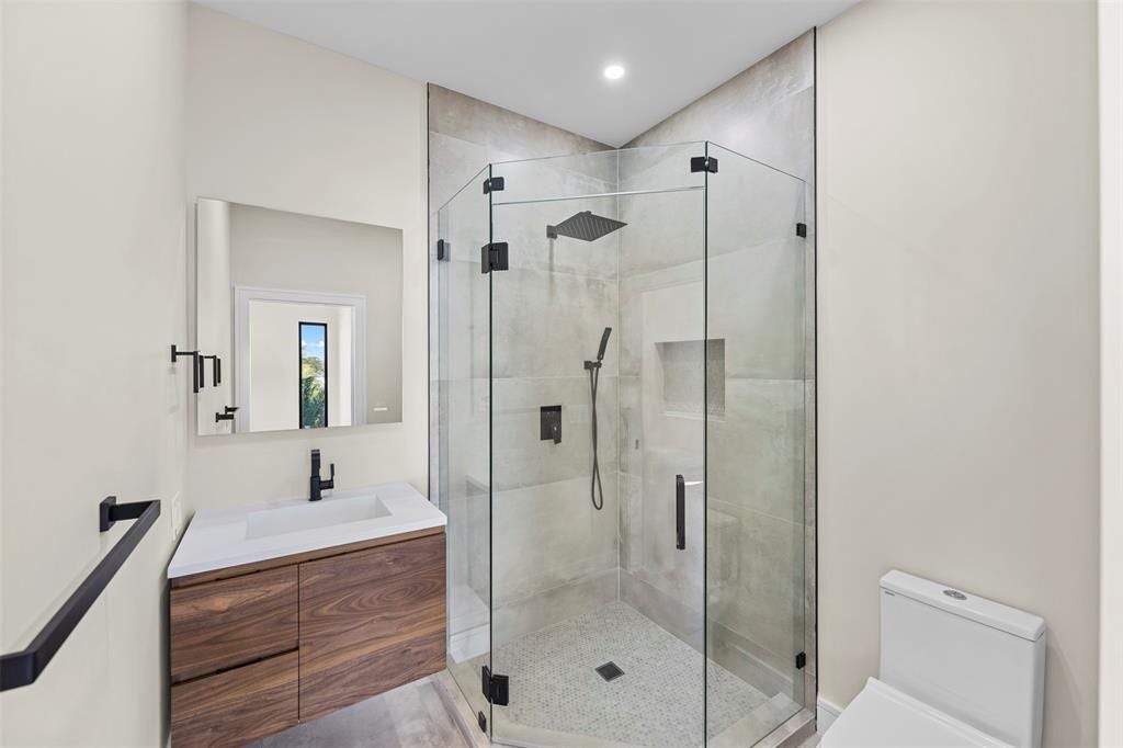 1212 AVOCADO Isle, Fort Lauderdale, Fort Lauderdale, FL 33315 Modern bathroom with a wood-finish vanity, integrated sink, and matte black fixtures