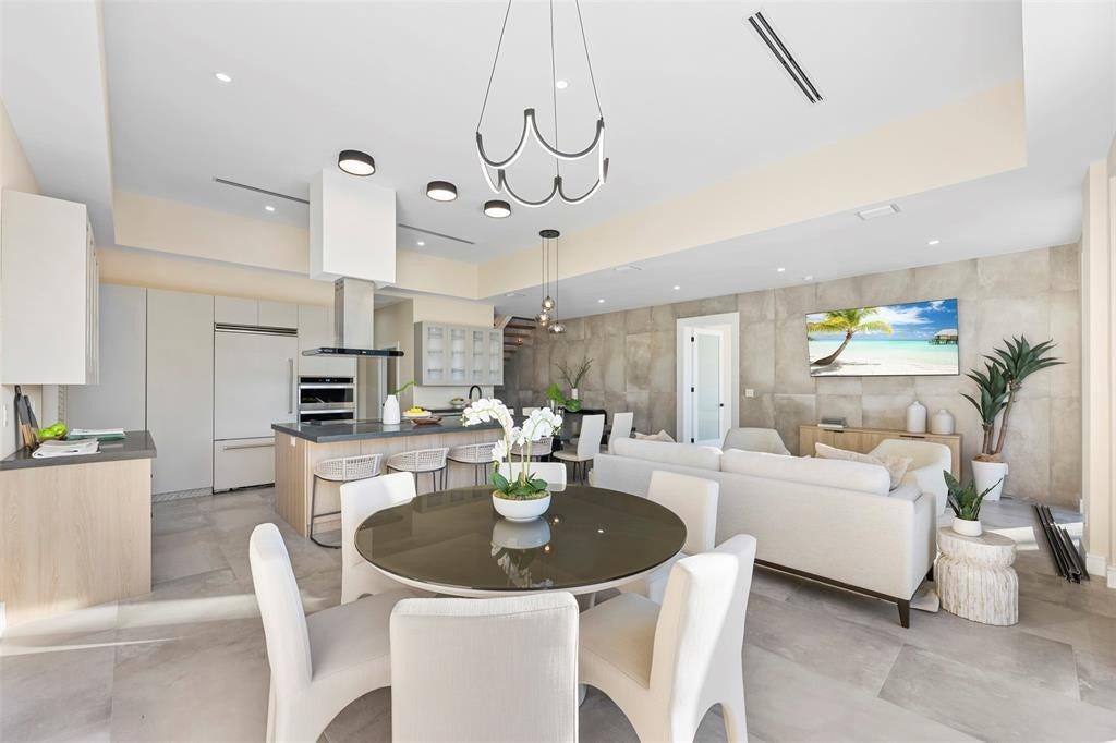 1212 AVOCADO Isle, Fort Lauderdale, Fort Lauderdale, FL 33315 Open-concept living space with large format tile flooring and a textured accent wall