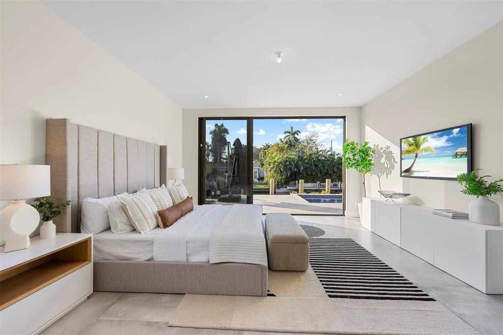 1212 AVOCADO Isle, Fort Lauderdale, Fort Lauderdale, FL 33315 Expansive glass sliding doors, recessed lighting, and a linear built-in media console
