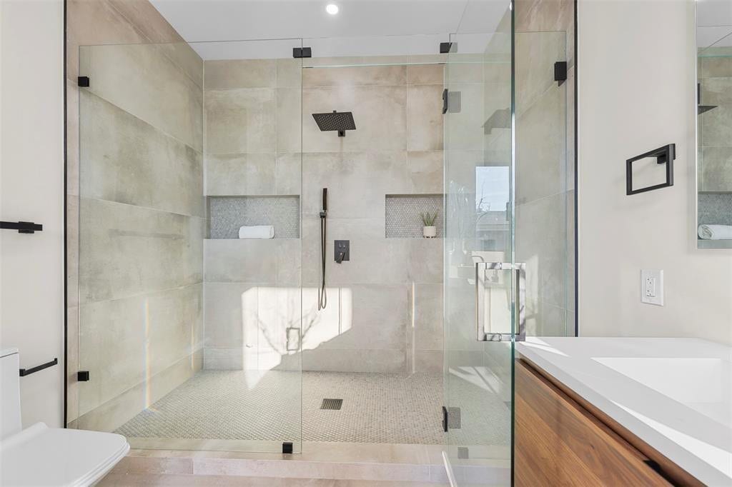 1212 AVOCADO Isle, Fort Lauderdale, Fort Lauderdale, FL 33315 Glass-enclosed shower with a matte black rain shower head and handheld sprayer