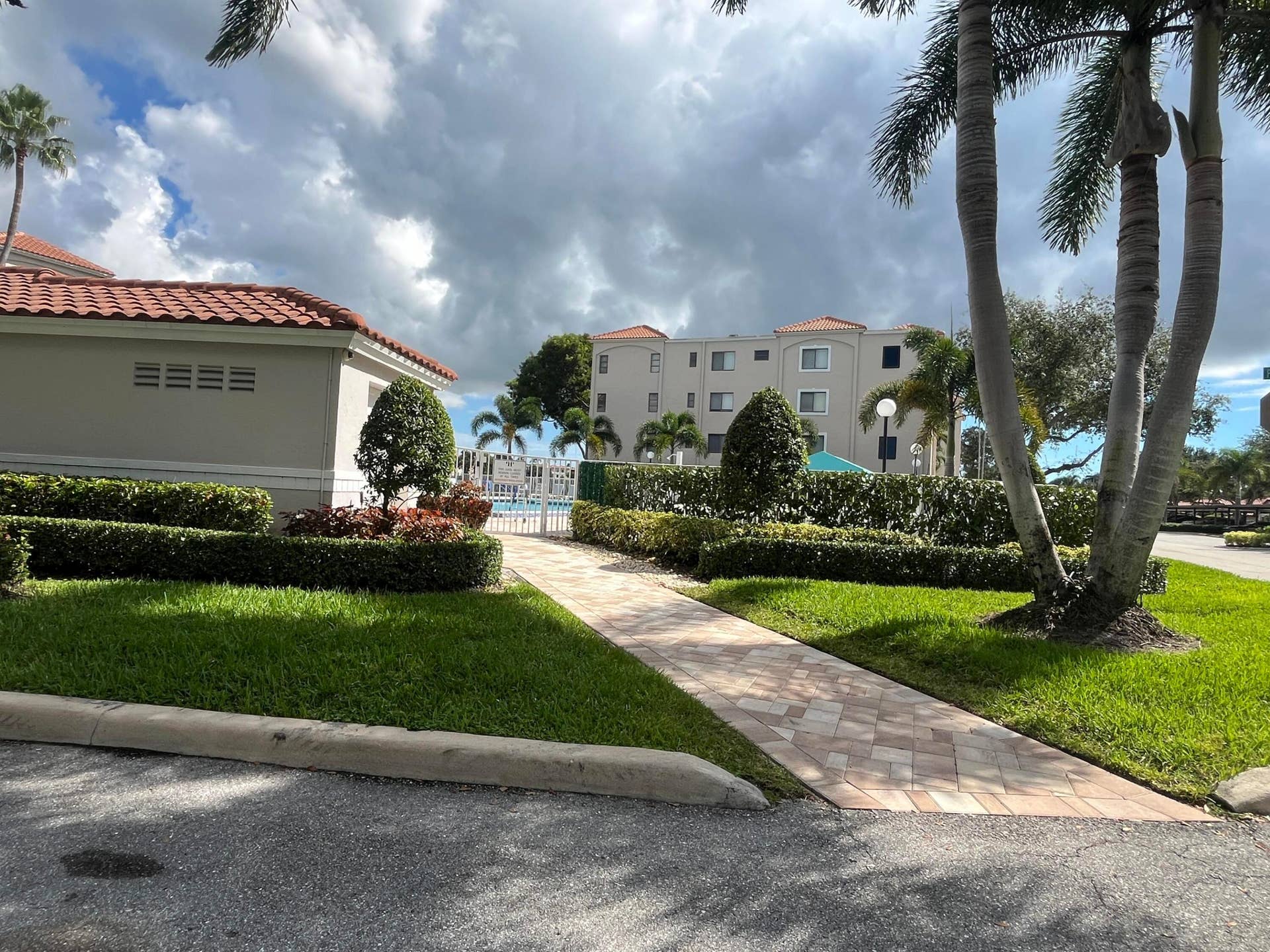 6269 Pointe Regal Circle, #305, Delray Beach, FL 33484 located next to the condo, the outdoor heated satellite pool entrance.