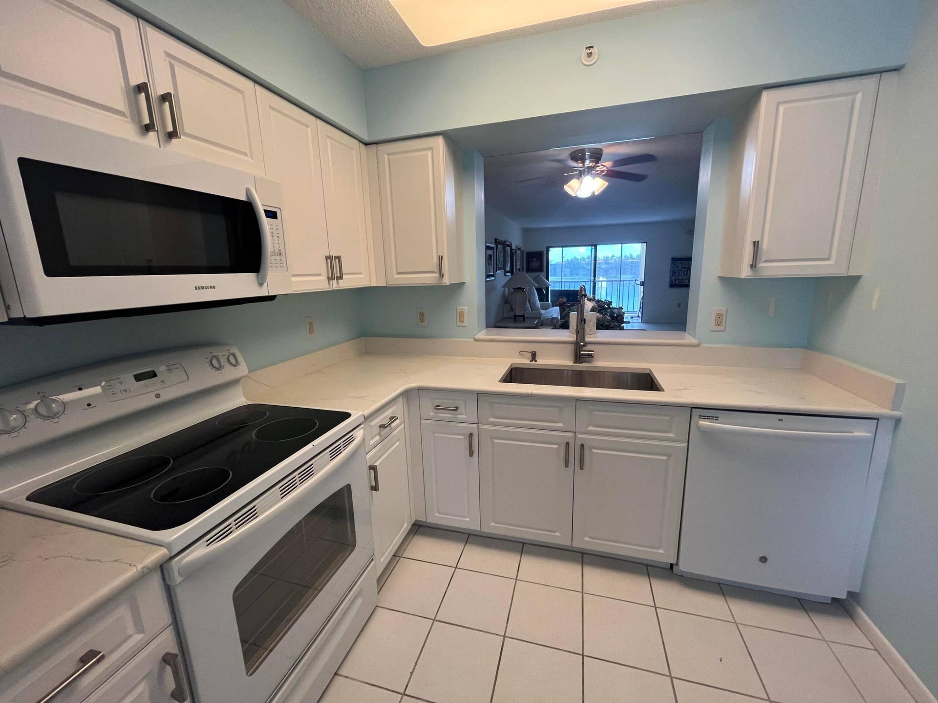 6269 Pointe Regal Circle, #305, Delray Beach, FL 33484 updated white shaker cabinets with all white appl.'s and a mounted microwave included.