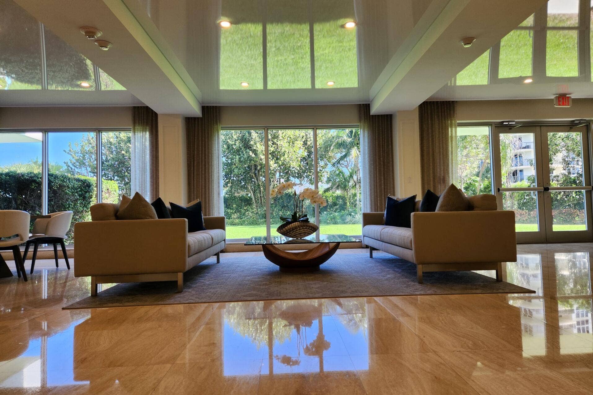 Polished stone flooring, expansive floor-to-ceiling windows, and recessed lighting