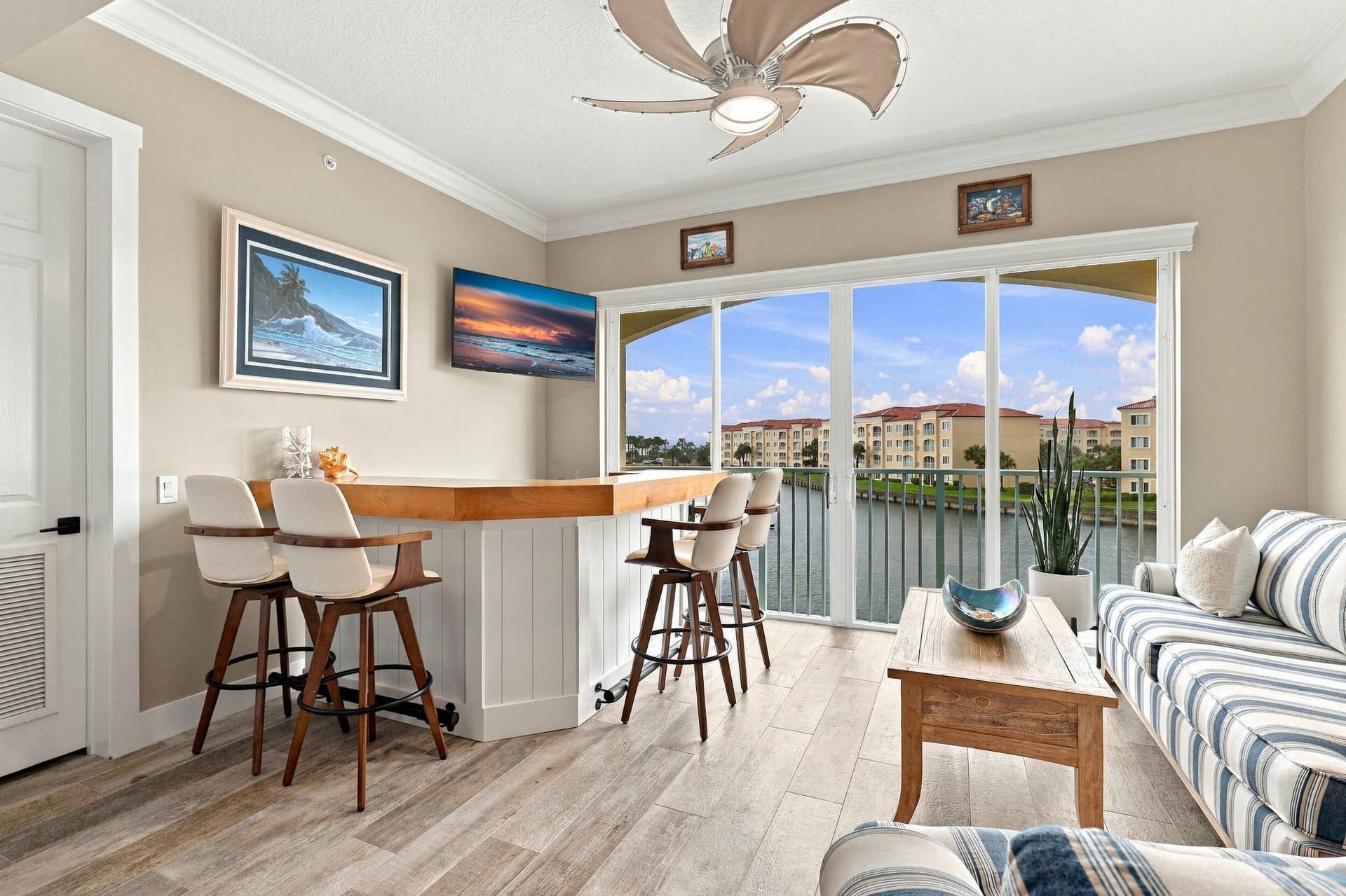 Sunroom features Custom Built-In Bar with Birchwood Top, Beverage/Wine Cooler, 4 Bar Stools, and Tinted Sliding Glass Doors providing for Energy Savings.