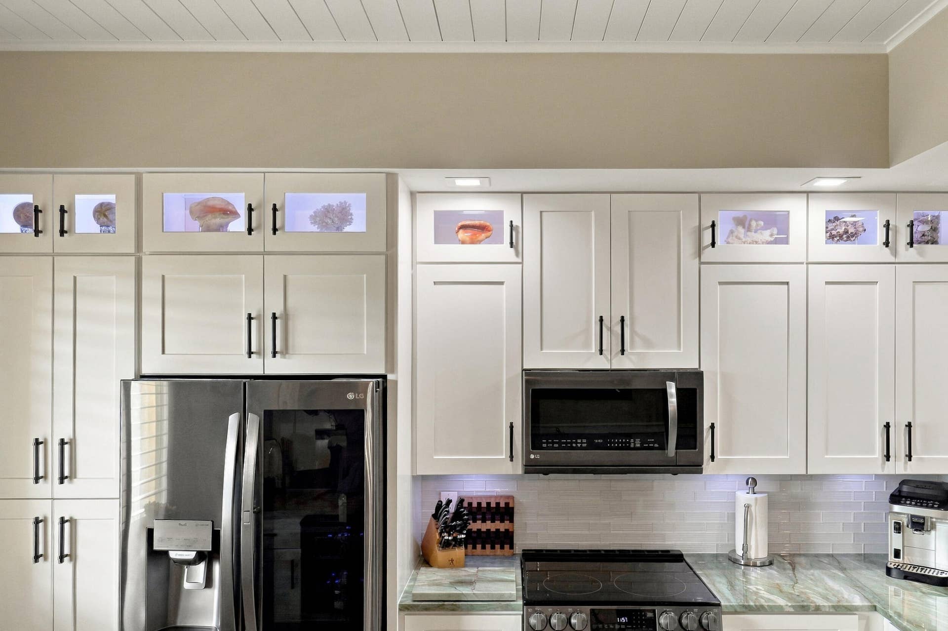Glass Door Top Cabinetry with Hard-Wired Lighting (ability to change colors). Custom Shiplap Ceiling