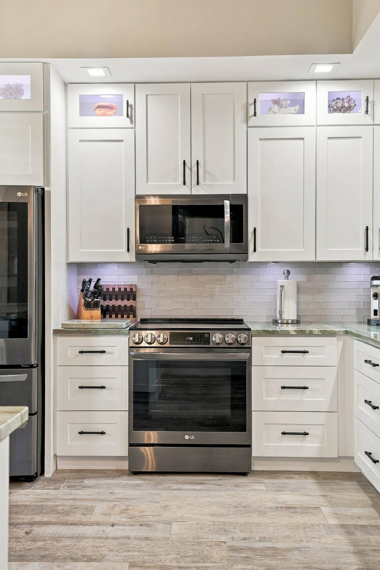 LG Black Stainless Instaview Electric Range  knock twice on glass to light up interior. Notice the above and below cabinet lighting (hard-wired and can change colors)