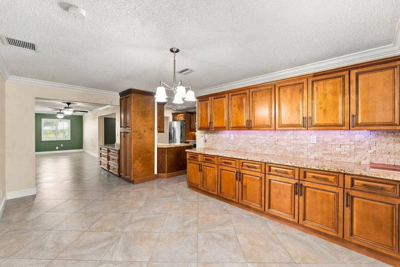 1707 SW 18th Street, Boynton Beach, FL 33426 Dining Room with beautiful wood cabinets and counterspace to match kitchen cabinets
