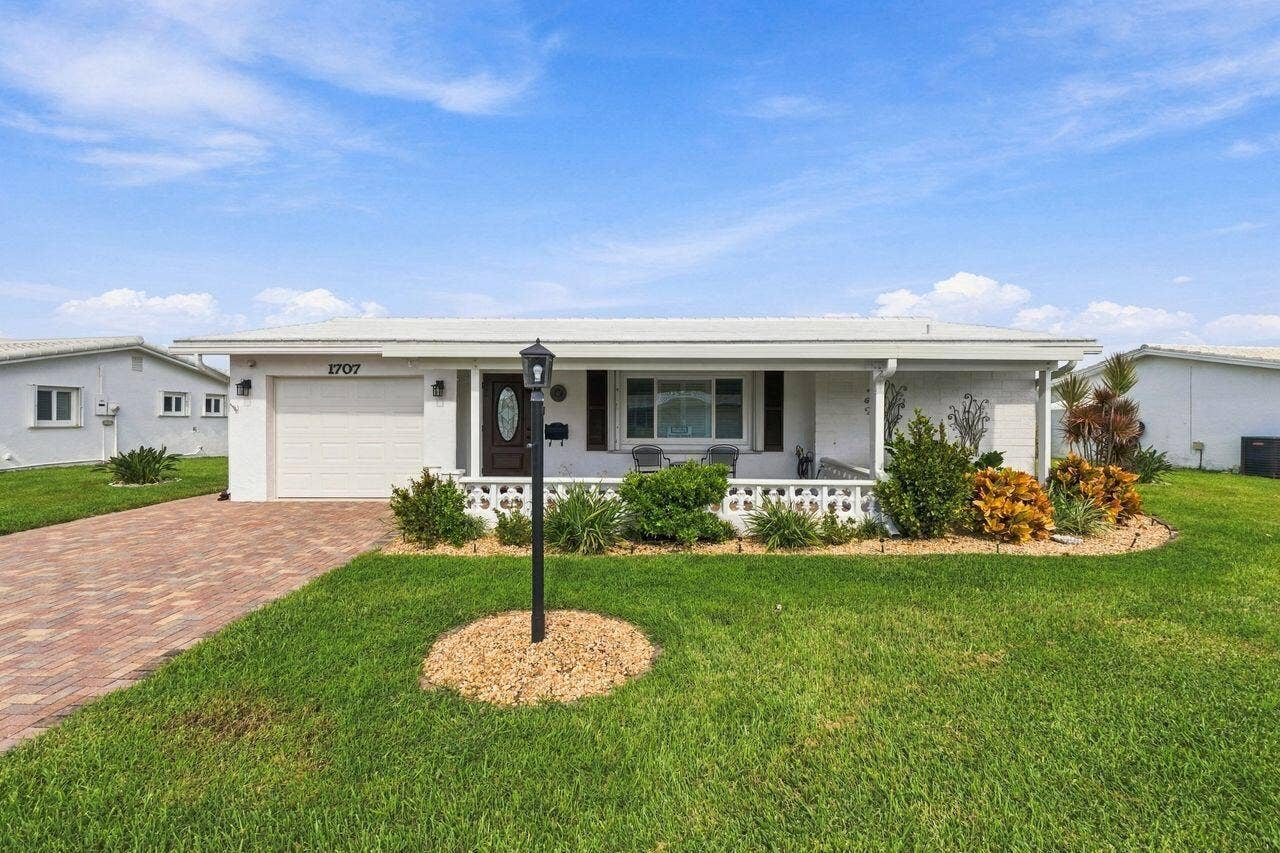 1707 SW 18th Street, Boynton Beach, FL 33426 Professional landscaping, large and covered front porch (2024) and beautiful paver driveway