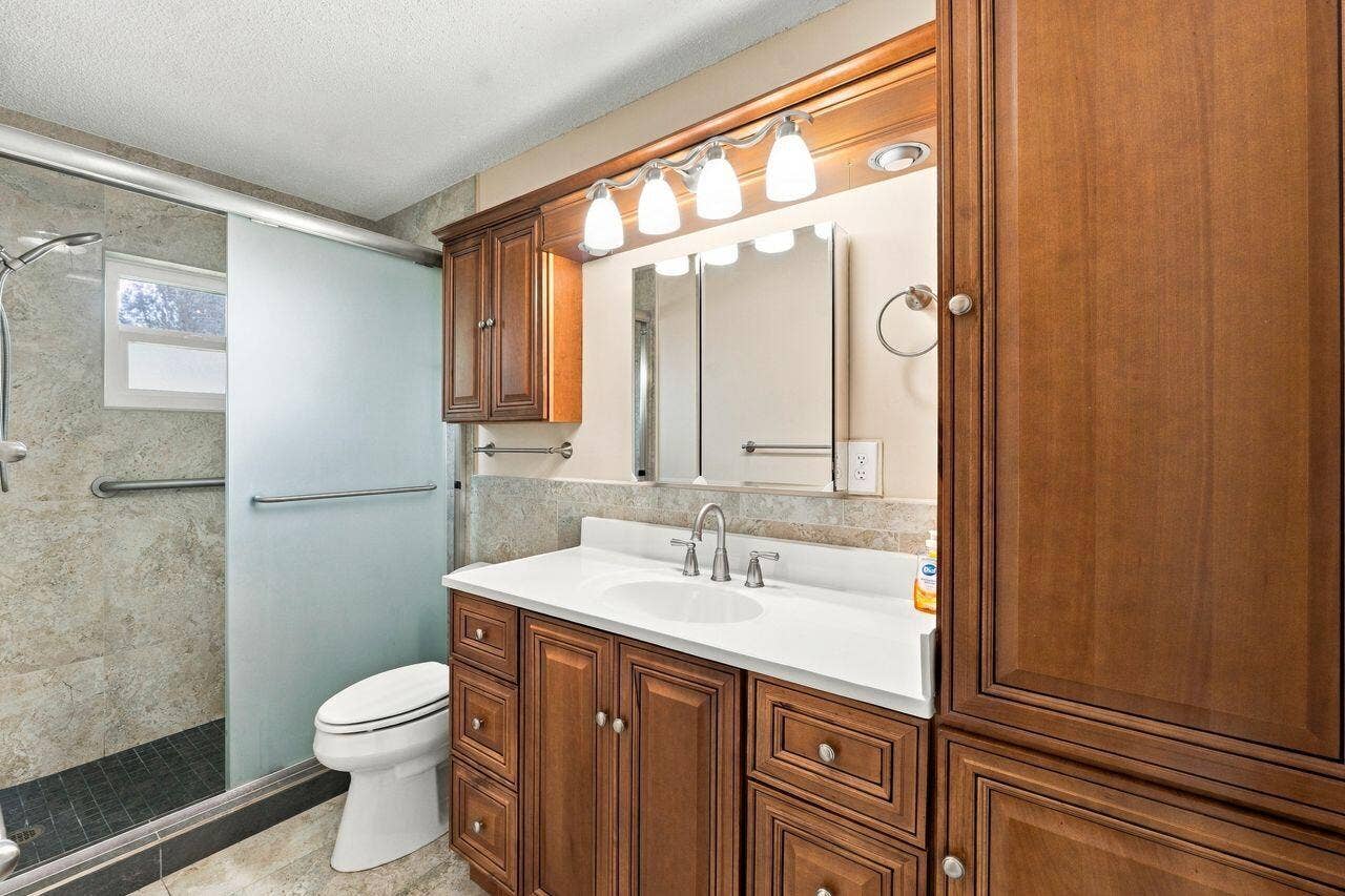 1707 SW 18th Street, Boynton Beach, FL 33426 Custom wood cabinetry with marble walk in shower