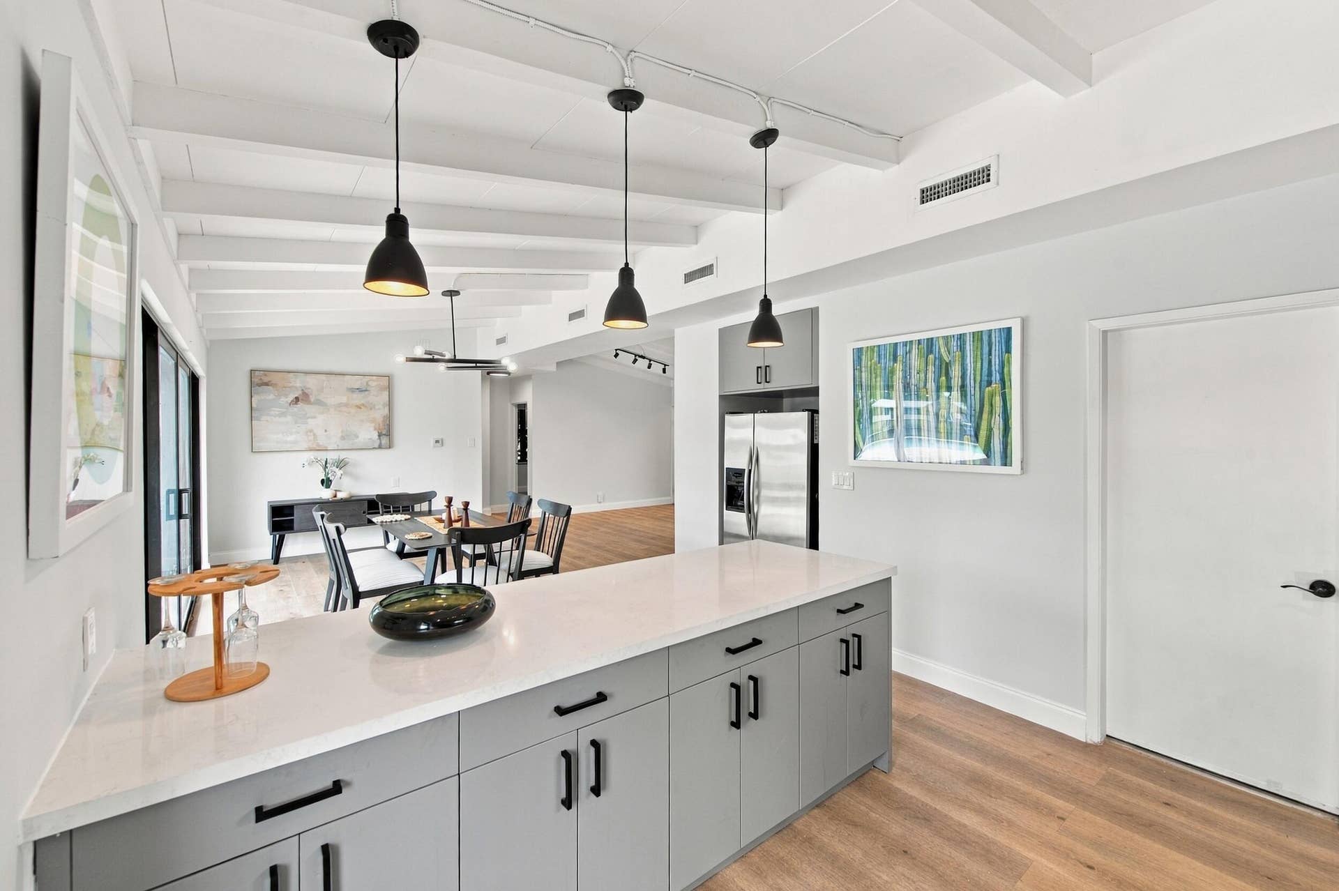 2536 GULFSTREAM Lane, Fort Lauderdale, FL 33312 Kitchen island with light gray cabinetry and a light-toned countertop, featuring three pendant lights overhead