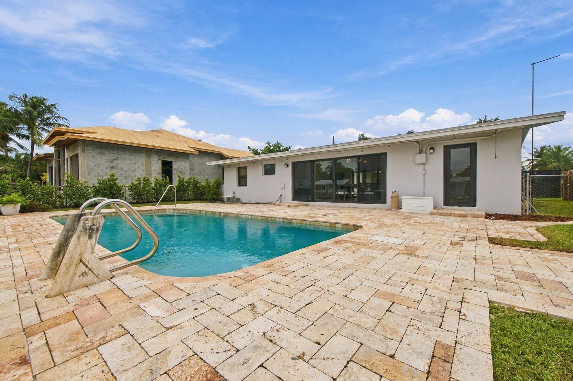 2536 GULFSTREAM Lane, Fort Lauderdale, FL 33312 Swimming pool with a diving board, surrounded by a stone paver patio
