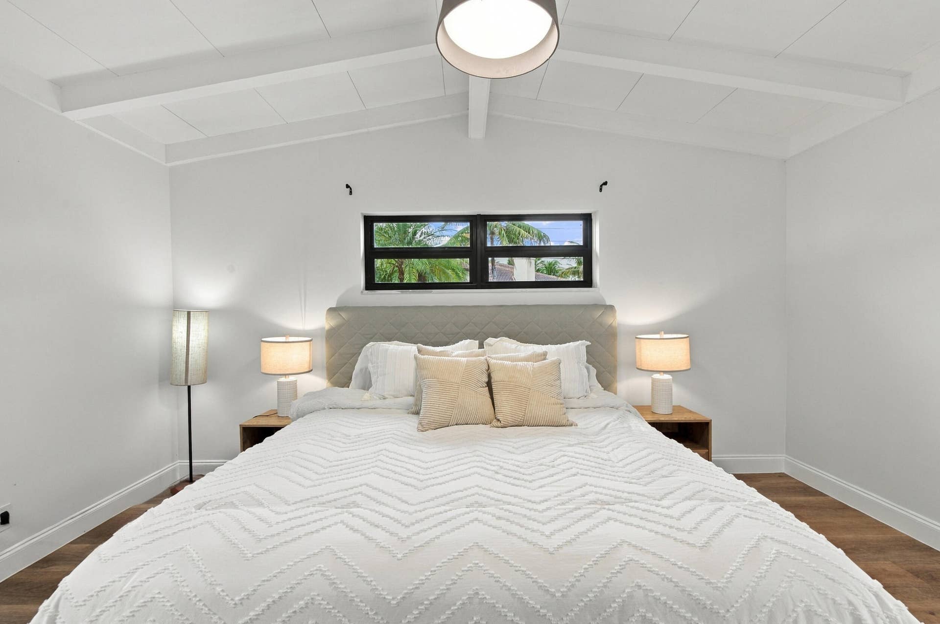2536 GULFSTREAM Lane, Fort Lauderdale, FL 33312 Vaulted ceiling with exposed beams, wood-finish flooring, and a black-framed window