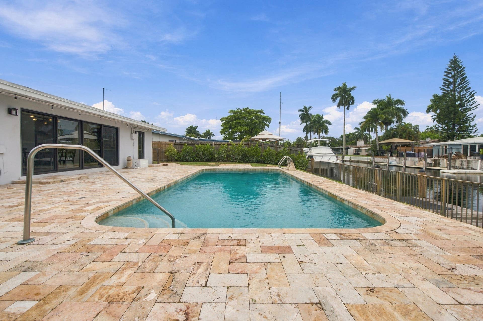 2536 GULFSTREAM Lane, Fort Lauderdale, FL 33312 Outdoor swimming pool with a curved entry, surrounded by a light-toned paver patio