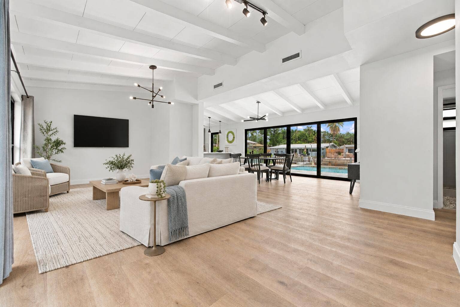 2536 GULFSTREAM Lane, Fort Lauderdale, FL 33312 Hardwood-finish flooring throughout, white coffered ceiling, modern linear chandelier, floor-to-ceiling windows, and recessed lighting