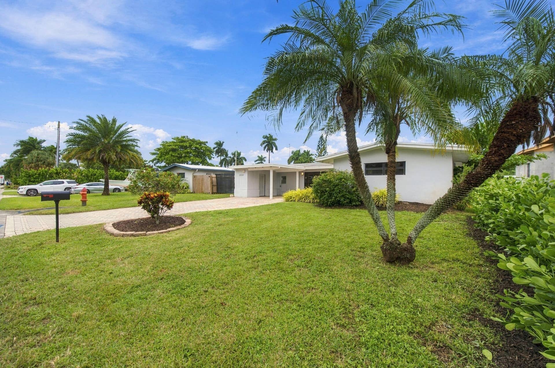 2536 GULFSTREAM Lane, Fort Lauderdale, FL 33312 Manicured lawn with mature palm trees and established landscaping