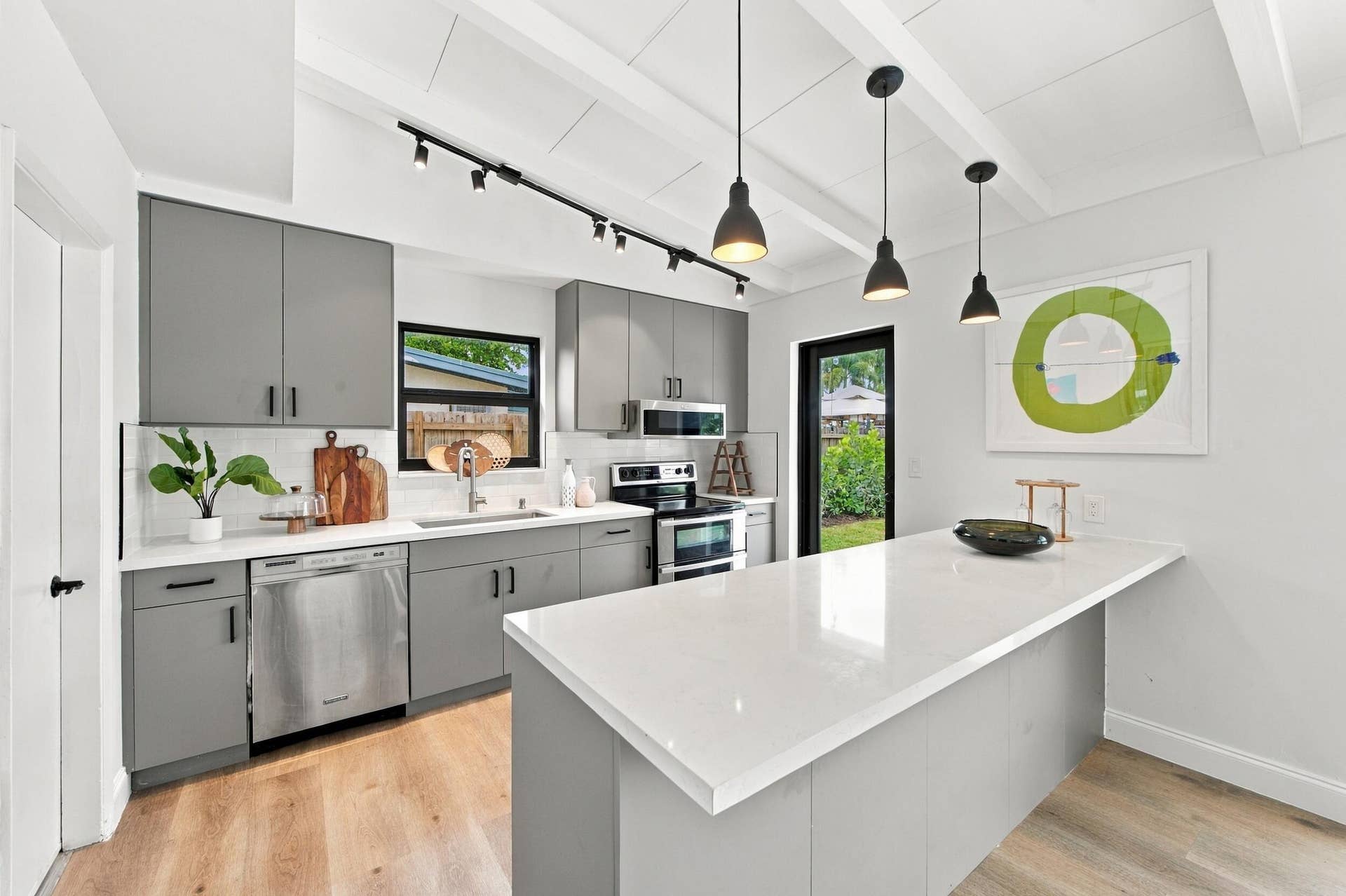 2536 GULFSTREAM Lane, Fort Lauderdale, FL 33312 Kitchen featuring wood-finish flooring, white countertops, gray cabinetry, track lighting, and pendant lighting
