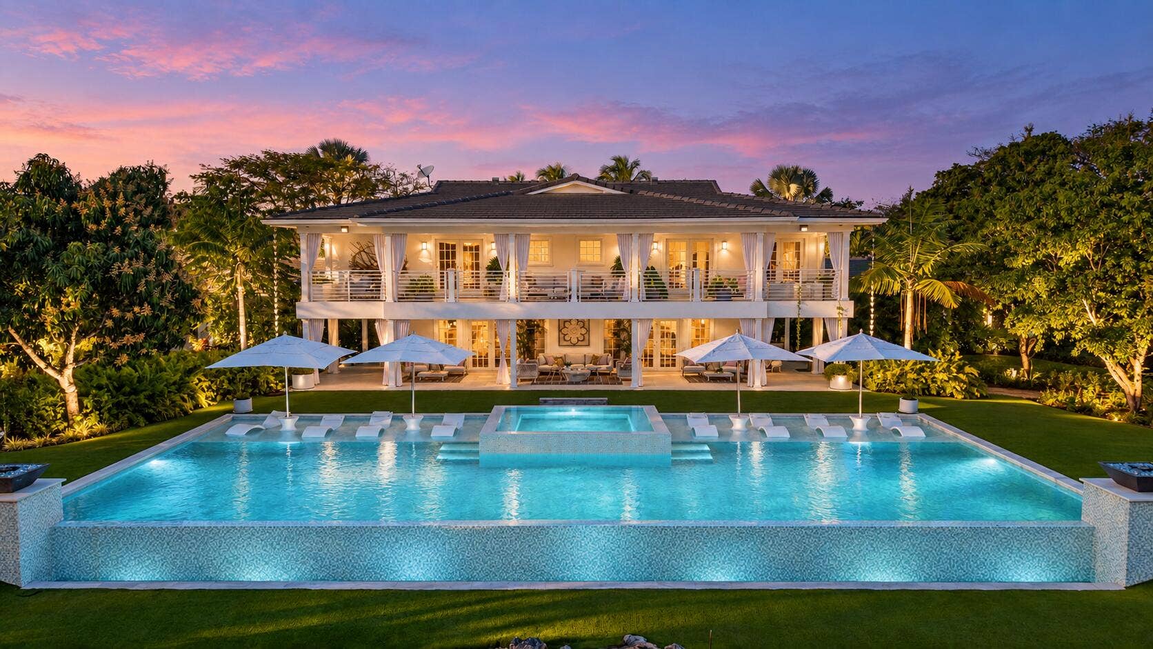 13920 Stirling Road, Southwest Ranches, FL 33330 Twilight luxury home with glowing infini