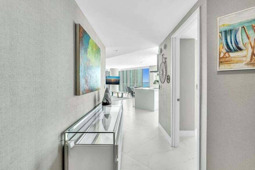 Sunny Isles Beach, Sunny Isles Beach, FL 33160 Hallway featuring textured wall coverings, recessed lighting, and white tile flooring