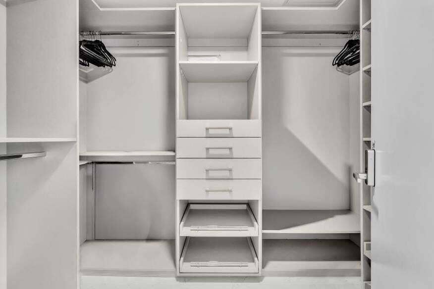 Sunny Isles Beach, Sunny Isles Beach, FL 33160 Custom closet system with multiple shelving units, integrated drawers, and chrome hanging rods
