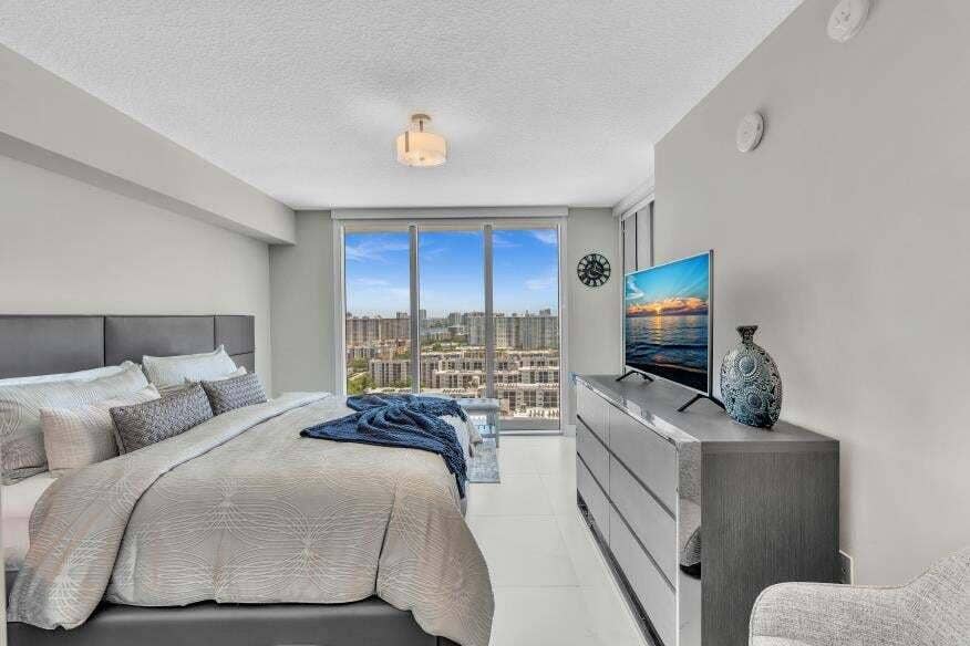 Sunny Isles Beach, Sunny Isles Beach, FL 33160 Full-height glass doors, recessed lighting, tile flooring, and a contemporary light fixture