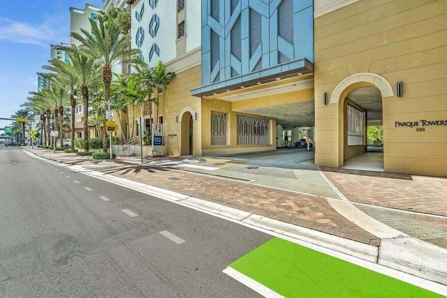 Sunny Isles Beach, Sunny Isles Beach, FL 33160 Street-level access to a multi-story building featuring a covered drive-through entrance