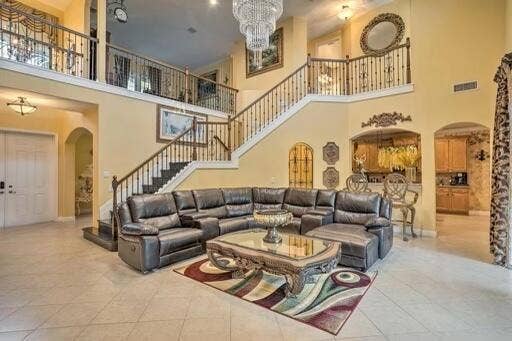 Two-story living area with an elegant staircase and wrought iron railings