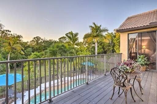 Balcony with composite decking, metal railing, and sliding glass door access
