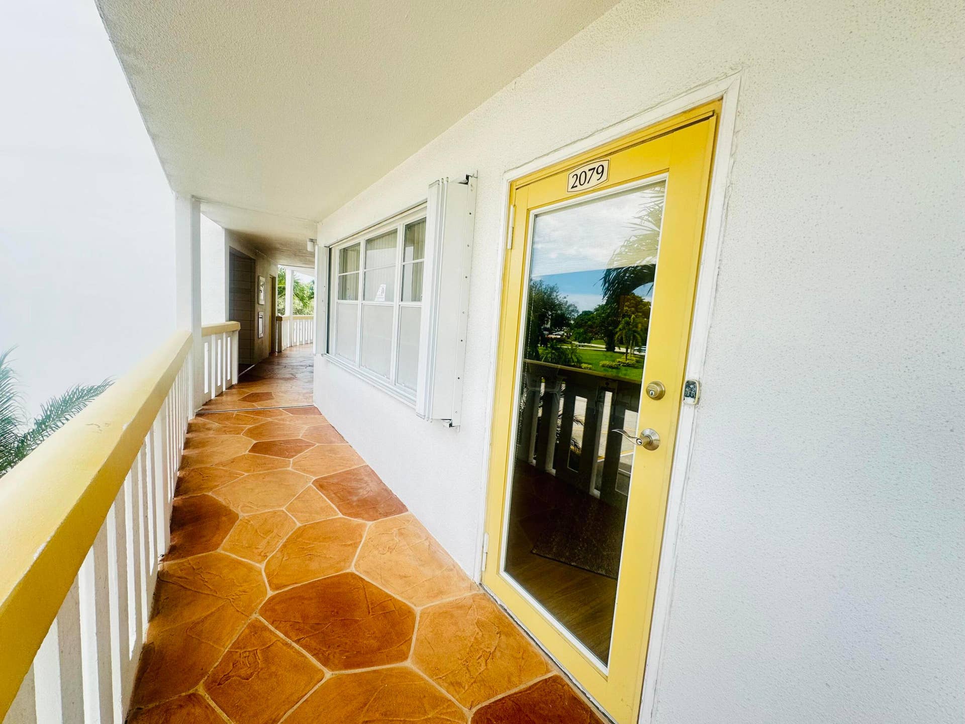 Entrance with Accordion Shutters on Front Windows