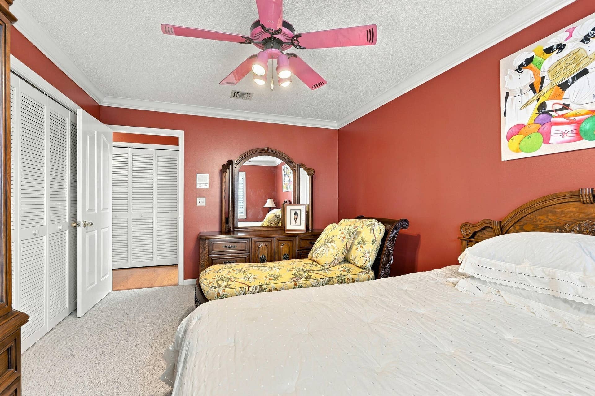 Plush carpeting and crown molding in a room with a ceiling fan