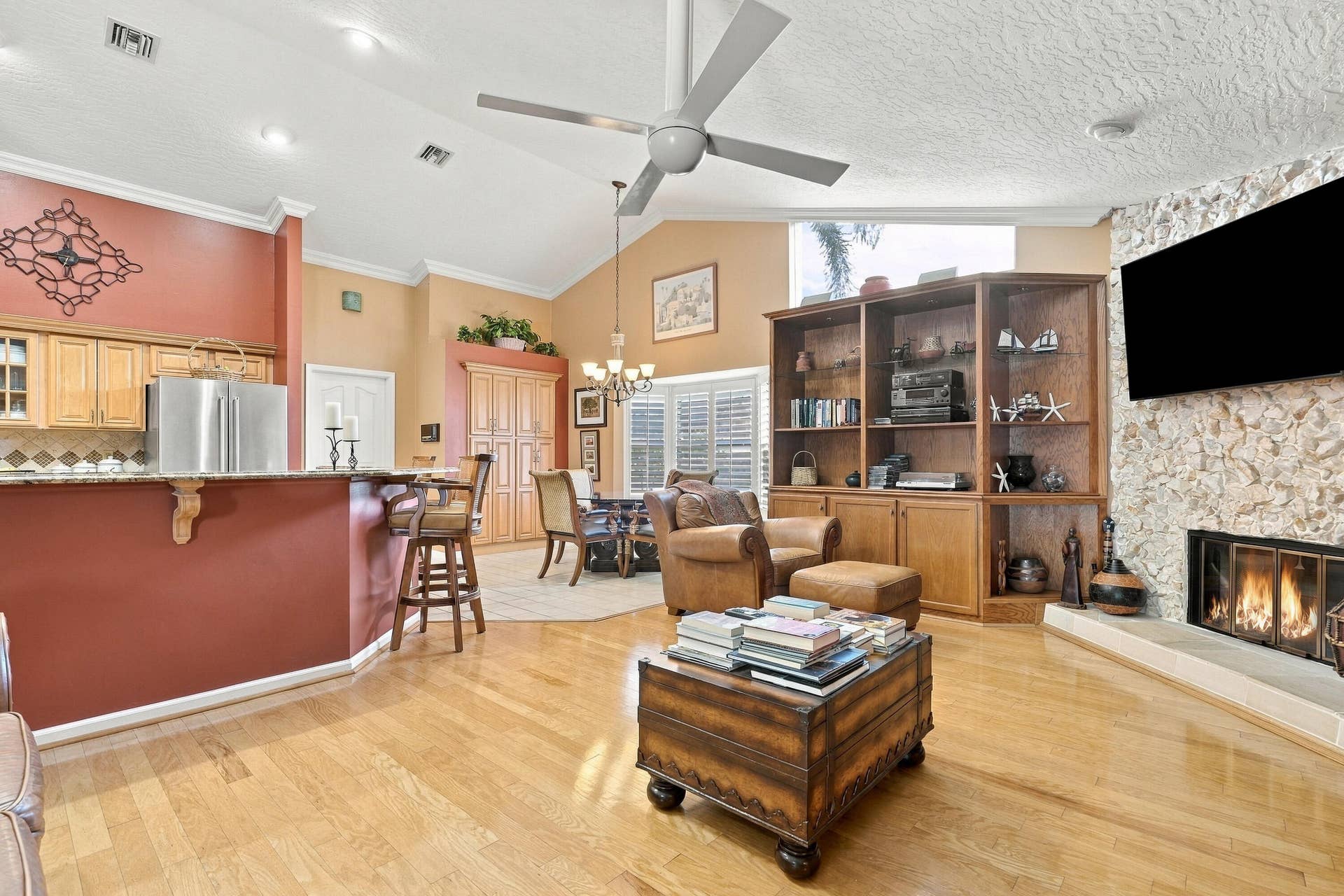 Wood-finish flooring, vaulted ceiling, and recessed lighting