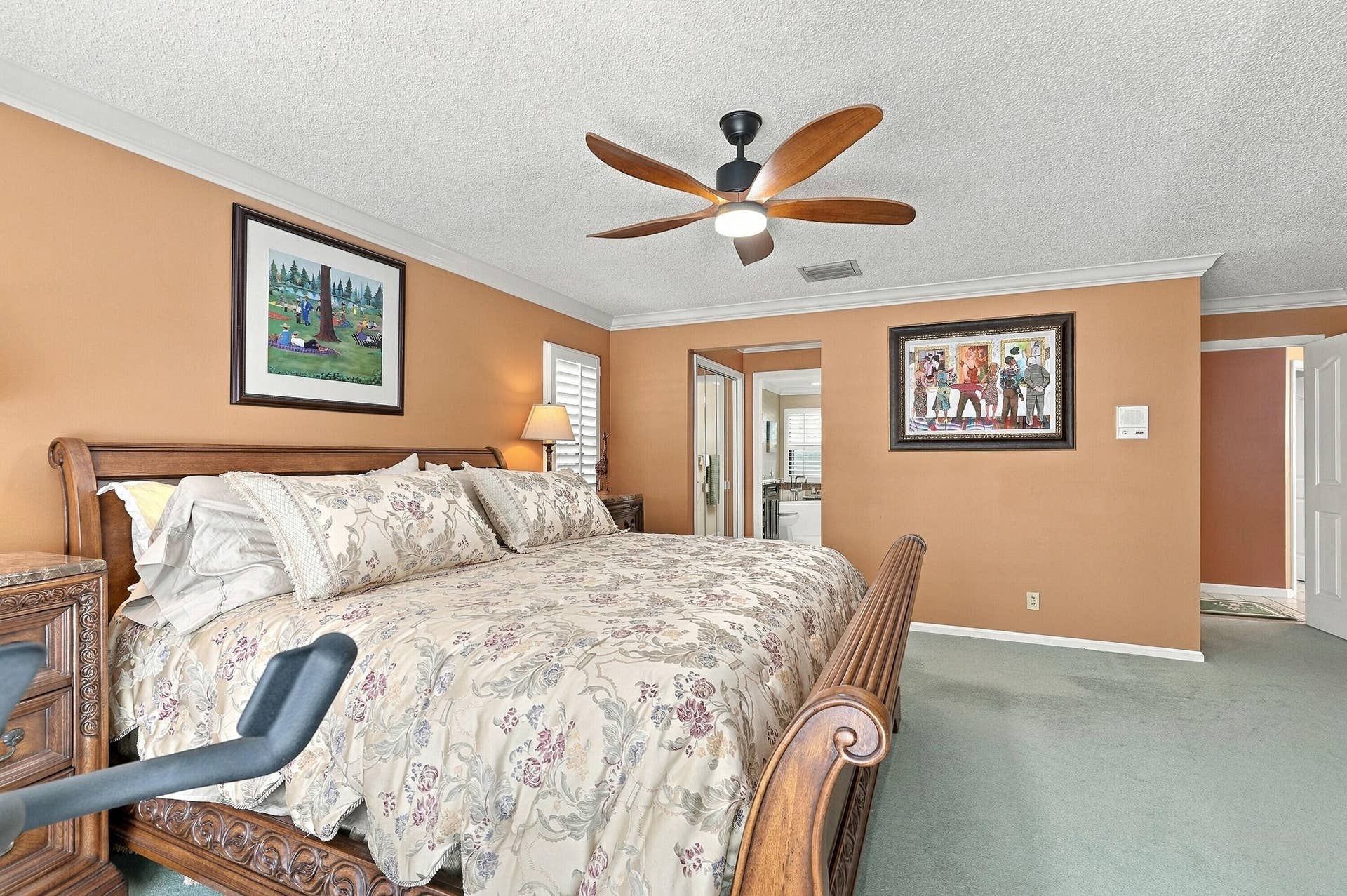 Room featuring a ceiling fan with integrated lighting, crown molding, and light-colored wall-to-wall carpeting