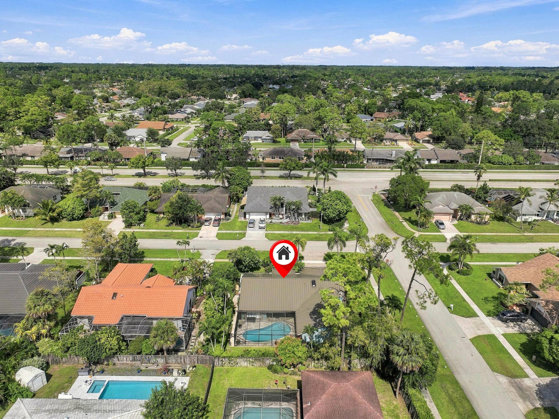 Aerial overview of a residential neighborhood with tree-lined streets