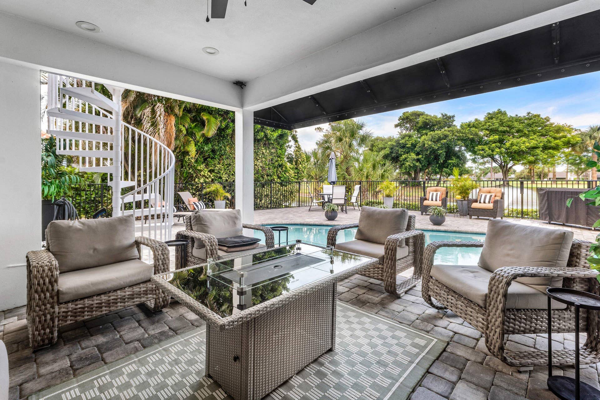 13138 Touchstone Place, Palm Beach Gardens, FL 33418 Covered patio with paver flooring, recessed lighting, ceiling fan, spiral staircase, and swimming pool